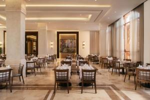 a restaurant with tables and chairs in a room at Charmillion Gardens Aquapark in Sharm El Sheikh +36 photos