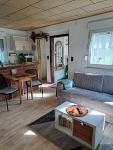 a living room with a couch and a table at Ferienhaus Hilde in Sangerhausen