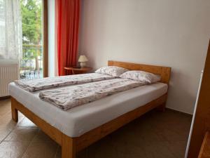 a large bed in a bedroom with a window at Kapitan Hook in Mielno