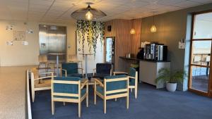 a dining room with a table and chairs in a room at Centre International de Séjour in Laval