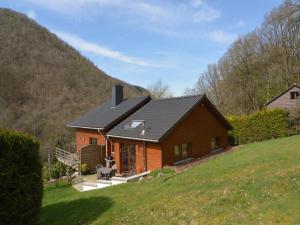 a house with a black roof on a hill at Cottage in Aywaille with Garden in Aywaille