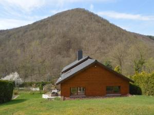 a log cabin with a mountain in the background at Cottage in Aywaille with Garden in Aywaille +27 photos