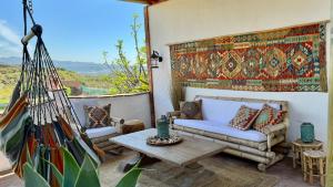 a living room with a couch and a table at Casa Bambú Boutique Studios Andalusië with pool and Mountain Views in Vélez-Málaga