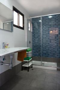 a bathroom with a shower and a sink and a tub at Apartamentos Miriam in Puerto Rico de Gran Canaria