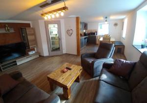 a living room with two couches and a coffee table at Ferienhaus Bumblebee im Allgäu in Eggenthal