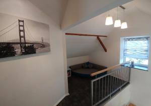 a room with a staircase with a bridge painting on the wall at Ferienhaus Bumblebee im Allgäu in Eggenthal