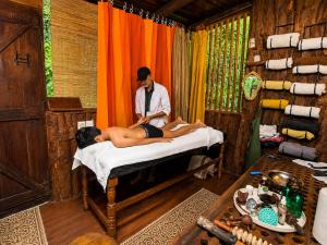 a man standing next to a man laying on a bed at Bliss Stay in Katugastota