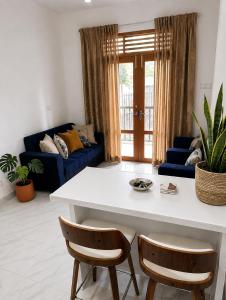 a living room with a white table and two chairs at Bliss Stay in Katugastota