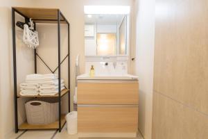 a bathroom with a sink and a mirror at NOVI Dotonbori in Osaka