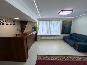 a waiting room with a blue couch and a window at DEMAL Mountain Resort in Alamedin +9 photos