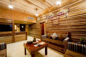 a living room with a couch and a table at Ras Al Khaimah Hotel in Ras al Khaimah