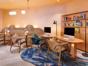 a room with two tables and chairs with computers on them at Mercure Istanbul Bakirkoy in Istanbul
