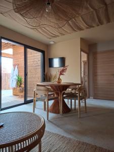 a living room with a wooden table and chairs at Refuge des Dunes in Marck
