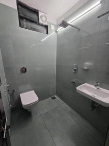 a bathroom with a toilet and a sink at Kukke Sai Skanda in Subrahmanya