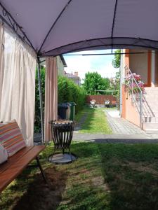 a patio with a bench and an umbrella at Noclegi Grota in Jasło