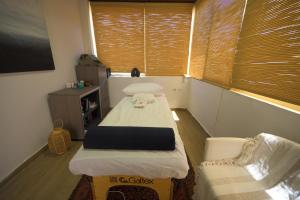 a small room with two beds and a chair at Lavender Boutique Hotel in Ramallah
