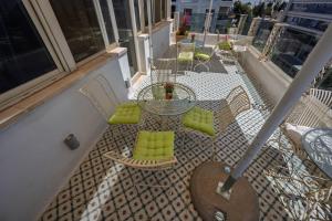 a balcony with a table and chairs on a building at Lavender Boutique Hotel in Ramallah