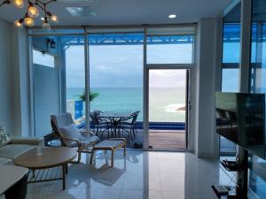 a living room with a view of the ocean at Youngdeok Bell Mar Poolvilla in Yŏngdŏk