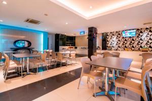 a dining room with tables and chairs in a restaurant at Hotel 88 Mangga Besar Raya 120 Jakarta By WH in Jakarta +27 photos