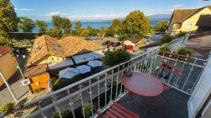 an apartment balcony with a view of a town at Le Bellevue in Excénevex