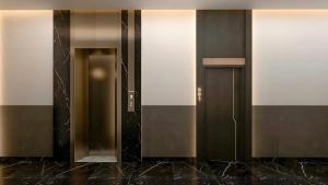 a row of elevator doors in a building at Dragon Hotel in Rạch Giá +38 photos