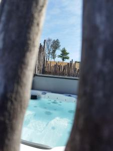 a view of a hot tub through a window at Au Grimp'Han in Han-sur-Lesse