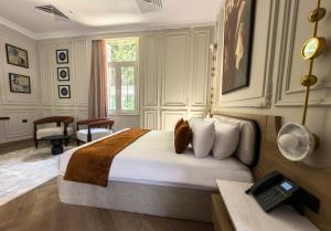 a hotel room with a bed and a telephone at AJIRA Zamalek Hotel in Cairo +8 photos
