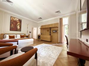 a bedroom with a bed and a living room at AJIRA Zamalek Hotel in Cairo