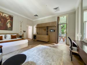a bedroom with a bed and a desk and a table at AJIRA Zamalek Hotel in Cairo