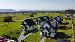 an aerial view of a village with houses at Prowincja Tatra Cottages Premium in Dębno