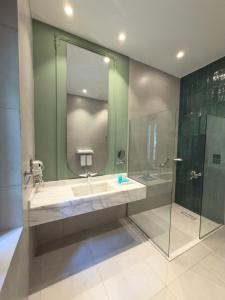 a bathroom with a sink and a shower at AJIRA Zamalek Hotel in Cairo