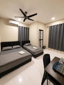 a bedroom with two beds and a ceiling fan at Casaria Beach in Paka +8 photos