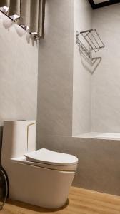 a bathroom with a white toilet and a bath tub at Paradise resort, Don Det river view in Don Det +92 photos