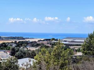 a view of a city with the ocean in the background at Elinor's Secret Suite in Sulam Tsor