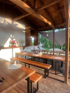 a room with wooden tables and benches in a building at Deleni Retreat - Glamping in Buzău