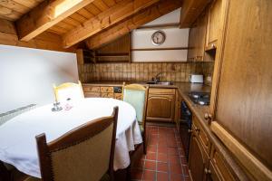 a small kitchen with a table and a sink at Hotel Hartenfels in Lech am Arlberg