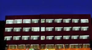 a large red building with illuminated windows at night at Ohris Baseraa in Hyderabad