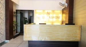 a lobby with a reception desk in a building at Hotel Jasmine in Ahmedabad