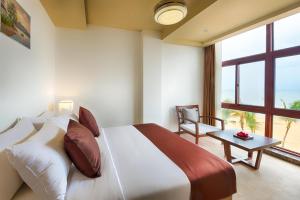 Kama o mga kama sa kuwarto sa Jie Jie Beach Hotel