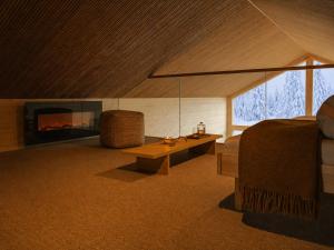 a living room with a bed and a fireplace at Ainur Villas in Saariselka