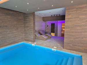 a swimming pool in a room with a house at Aurora Lux Wellness & Spa in Veliko Gradište