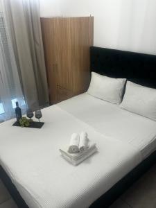 a bedroom with a bed with towels on it at Panthera-urban-studio in Xanthi