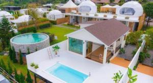 an aerial view of a house with a swimming pool at Stratus Resort in Khao Kho