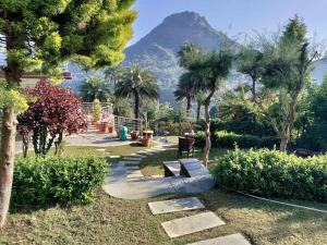 a park with a bench with a mountain in the background at Grand Valley - A Boutique Resort in Mount Abu in Mount Ābu