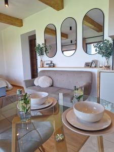 a living room with a glass table and mirrors at Apartament Polana No 24 in Bańska Wyżna