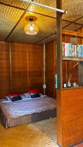 a bed in a room with a book shelf at Slow Home in Ban Yang Mae Luang