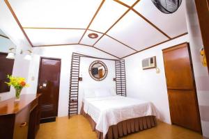 a bedroom with a bed and a mirror on the ceiling at Steps Garden Resort in Sabang +274 photos