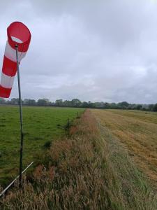 a red and white flag in the middle of a field at Sky and Bel Air in Saint-Philbert-de-Bouaine