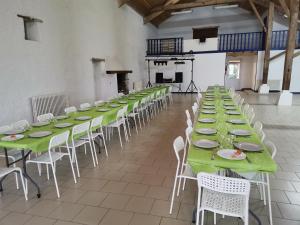 a large room with green tables and white chairs at Sky and Bel Air in Saint-Philbert-de-Bouaine