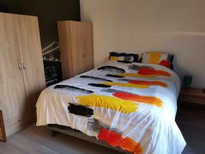 a bedroom with a bed with a colorful quilt on it at Sky and Bel Air in Saint-Philbert-de-Bouaine